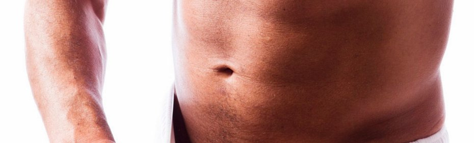 A man enlarges his penis with a vacuum pump