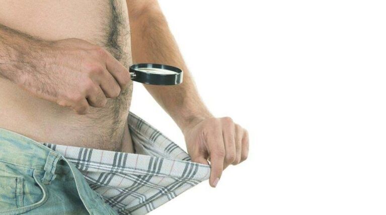 a man looks into his underpants and thinks about penis enlargement with soda